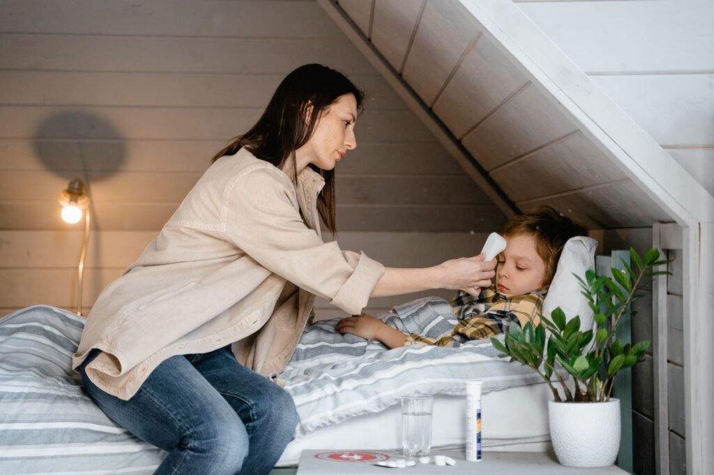Parent checking a child with chickenpox for fever