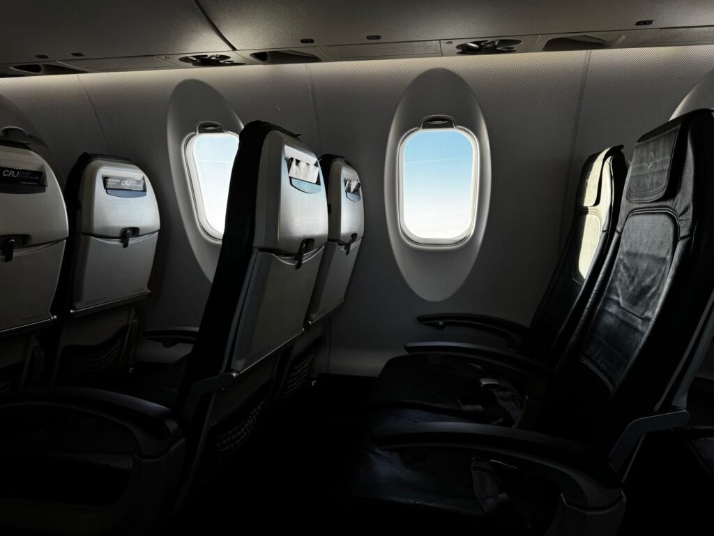 Passenger looking out an airplane window after fit to fly clearance